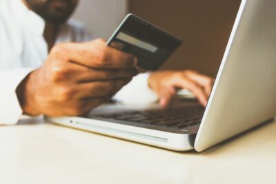 A consumer using a credit card to make a purchase, reaching the end of the sales funnel.